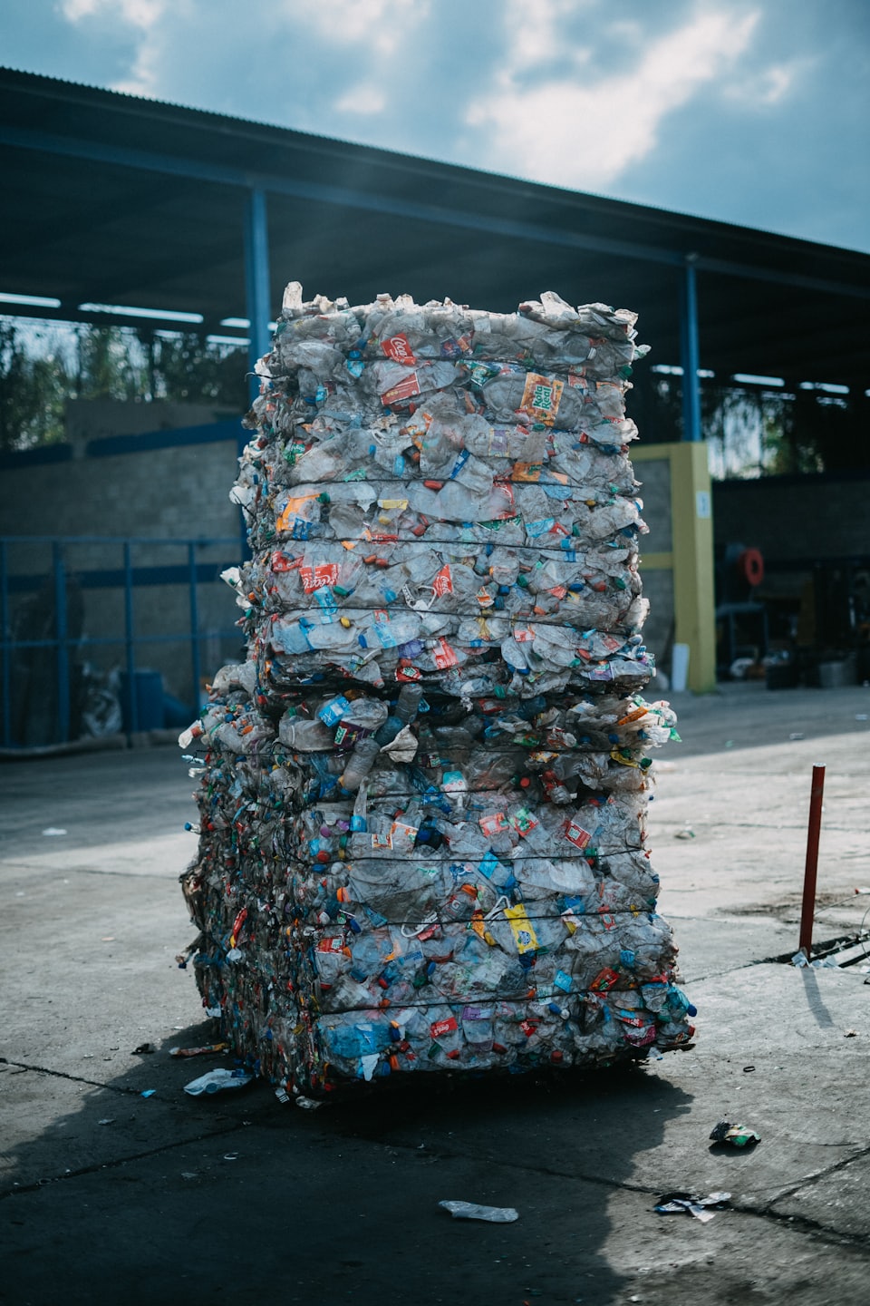 Compressed plastic bottles are stacked at a recycling facility.